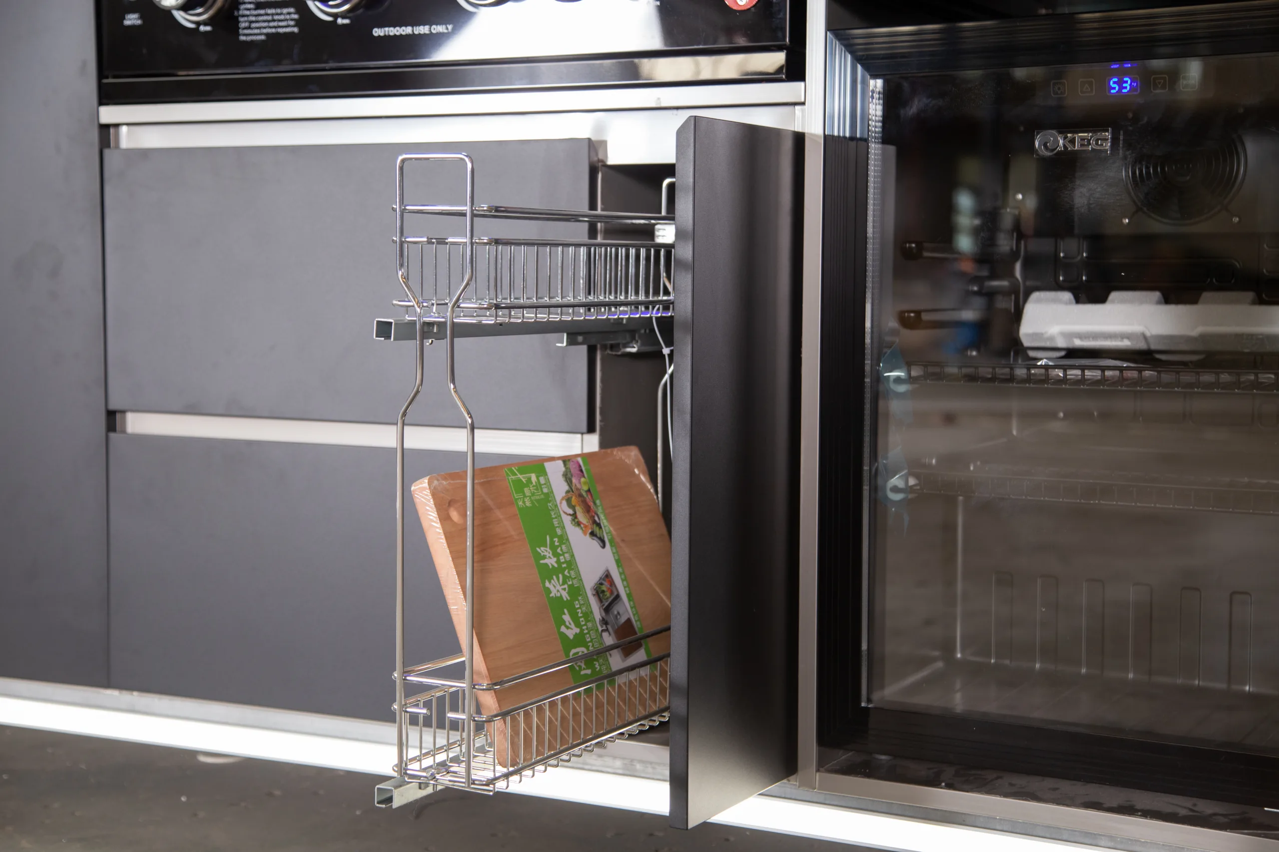Pull-out storage baskets inside a Meta Lifestyle enclosed outdoor kitchen